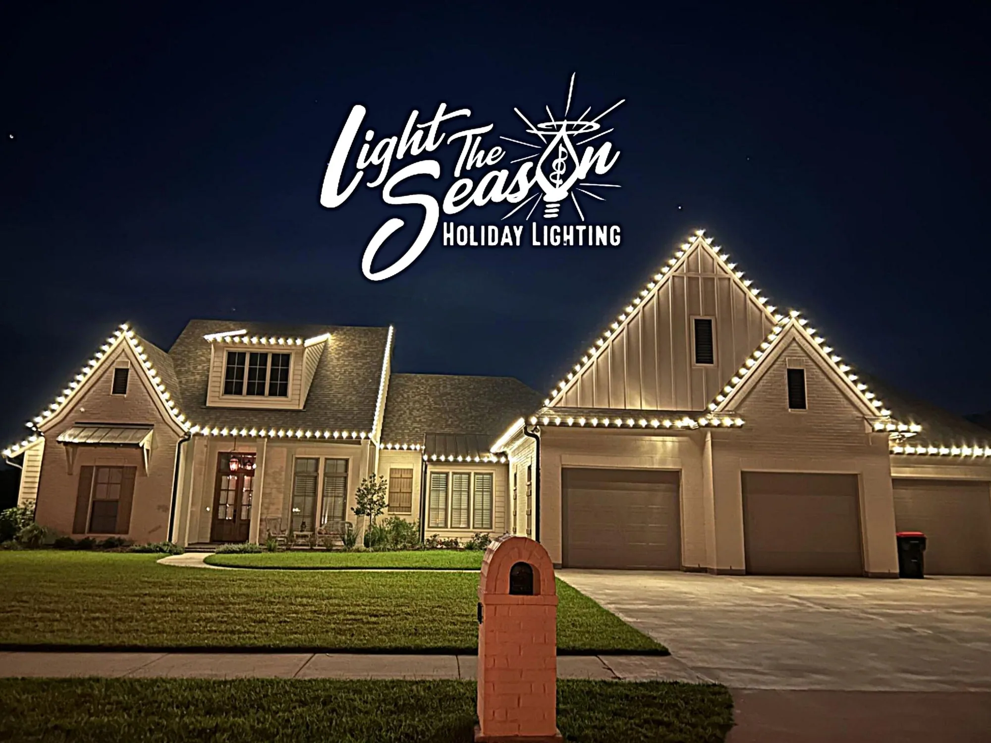 Modern farmhouse at night with crisp warm-white Christmas lights along every roofline and gable