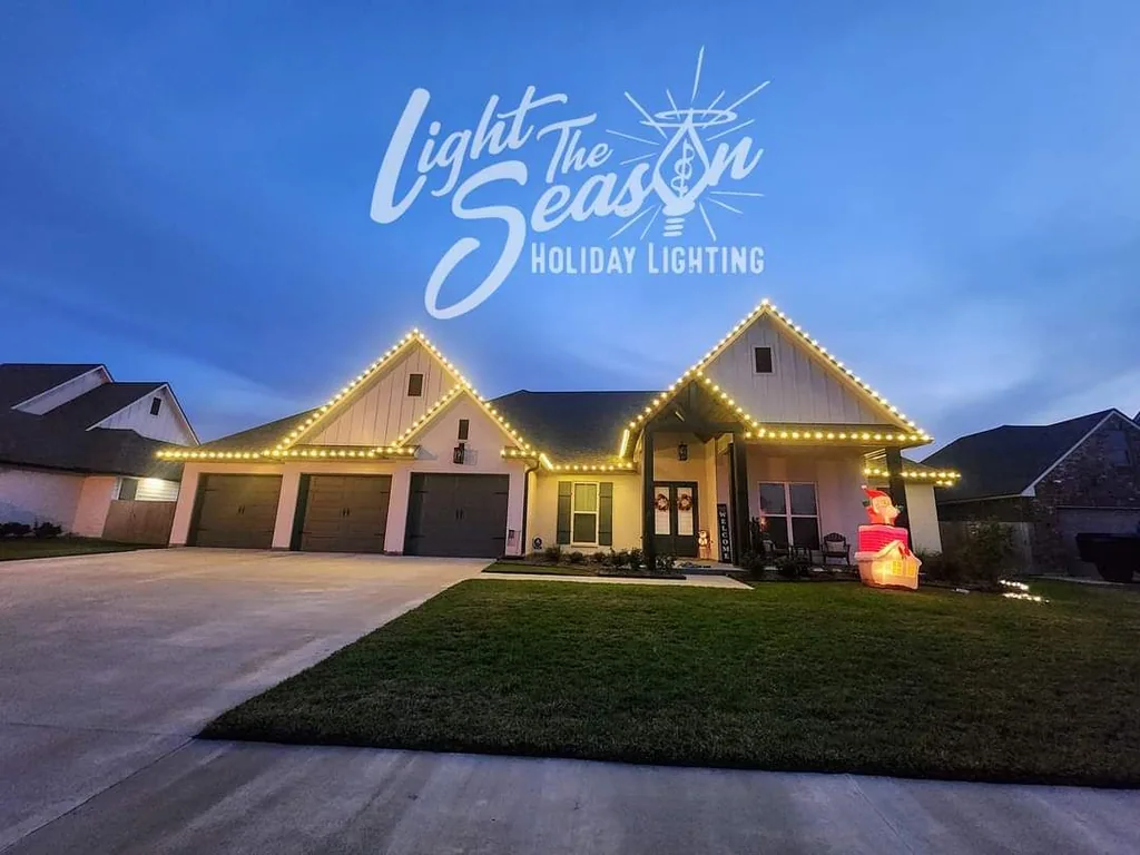 Modern farmhouse at twilight with warm-white roofline lights and a lit entry